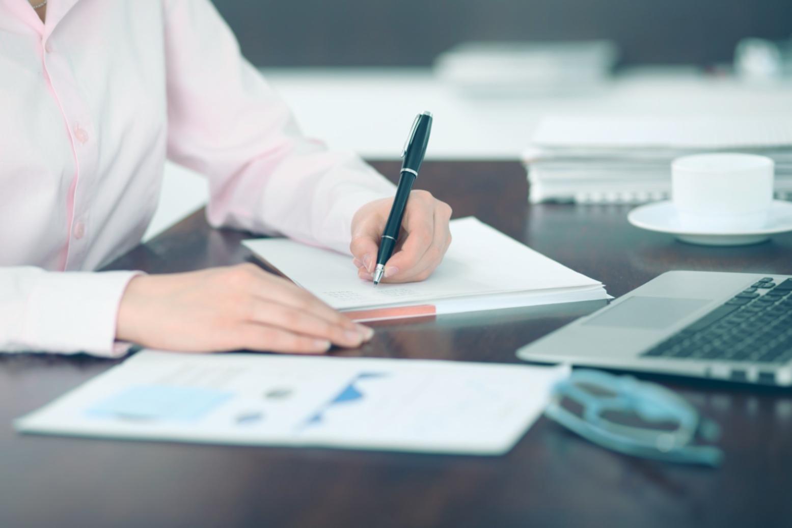 Business owner reviewing financial reports with organized documentation